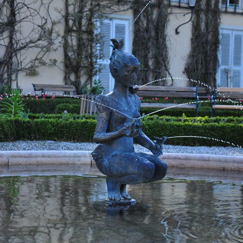 Kneeling female bronze fountain statue in the Mirabell Palace and Gardens DZB-55