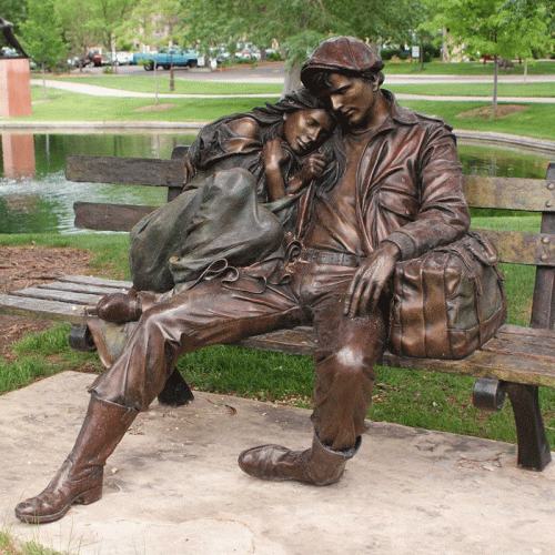 Life size street art bronze sculpture of a yong man and woman snuggle up in a chair DZB-14