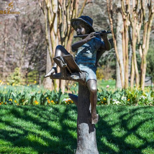 Boy playing the flute beonze statue on the tree trunk DZB-93