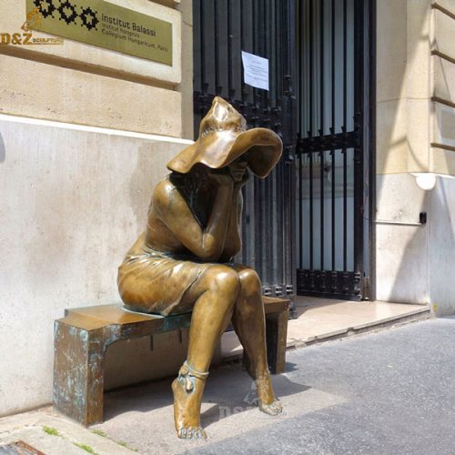 Life size seated peasant girl outside the Hungarian Institute bronze statue DZB-129