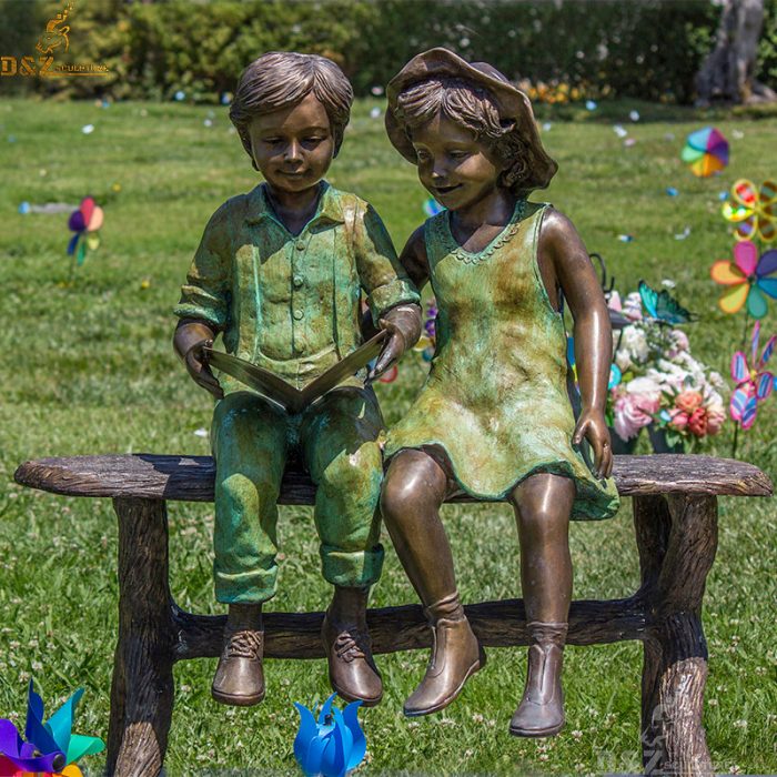 Boy and girl on beach reading ourdoor garden bronze statue DZB-208