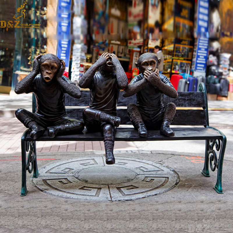 Three wise monkeys sitting on a bench bronze statue see no evil hear no evil speak no evil